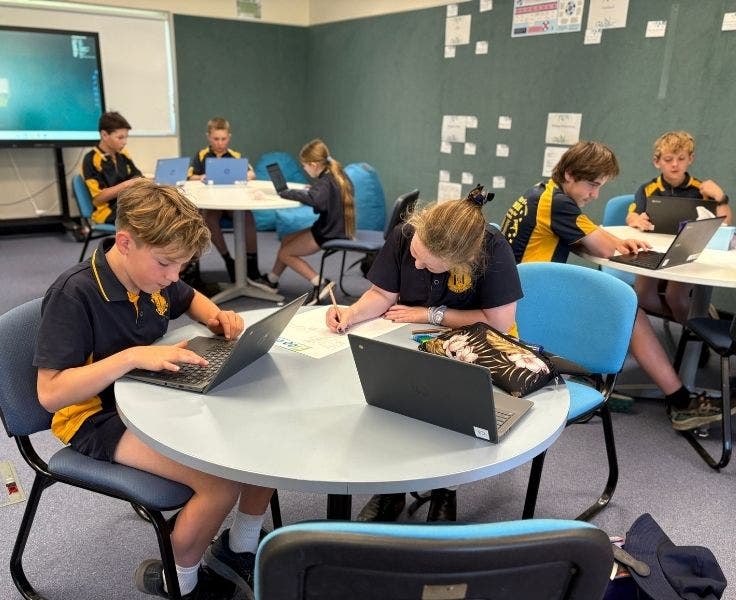 students working at desks in the Hub.