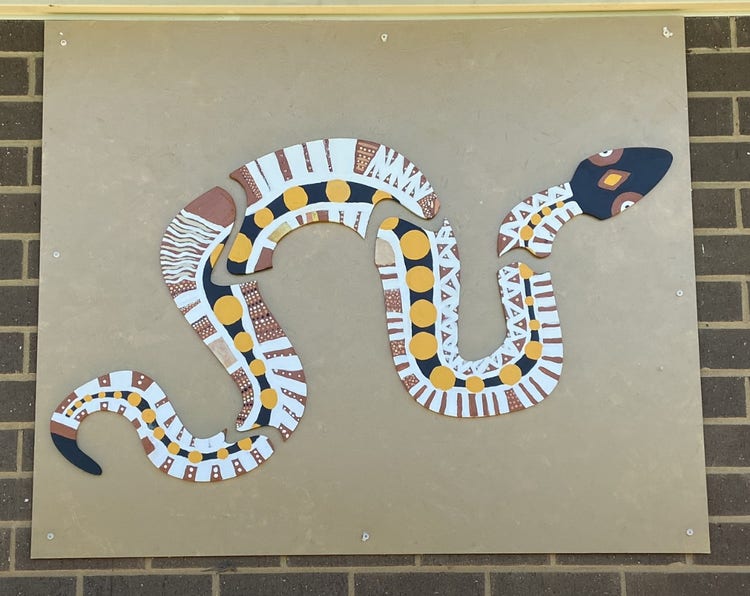 a large Indigenous Mural of a snake which is displayed on one of the exterior walls in our school.