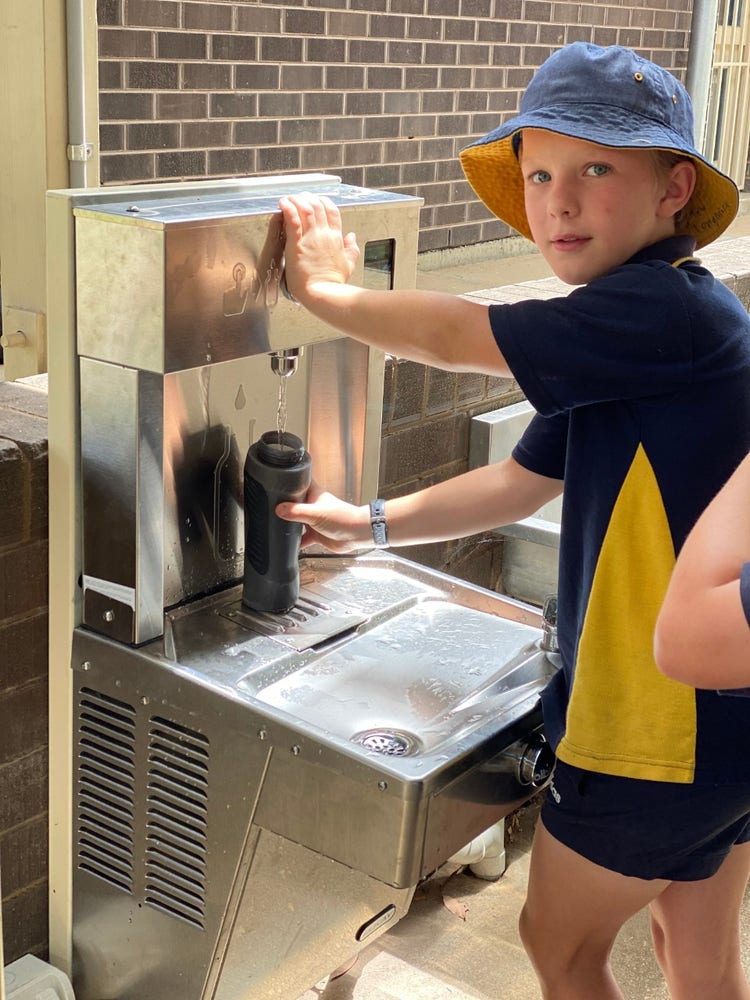 a student filling up his drink bottle at our cooled water station.