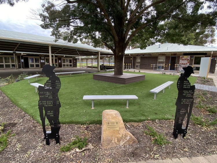 ANZAC Garden, view of the two metal soldier statues and plague.